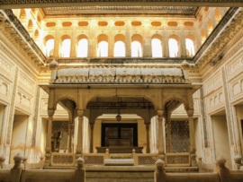 Golden rays of sunlight casting a warm glow inside Paigah Tombs