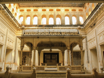 Golden rays of sunlight casting a warm glow inside Paigah Tombs