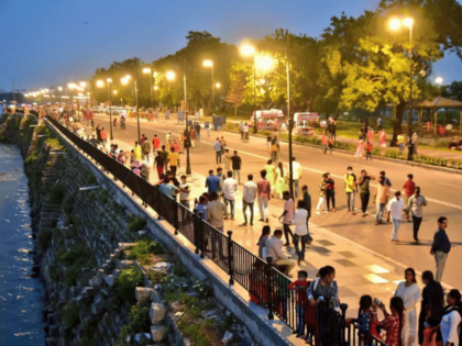 Visitors savoring the fresh air and beautiful scenery at Tank Bund, Hyderabad