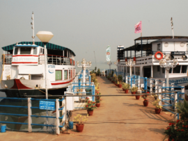 Serene view of docked boats at Lumbini Park, bathed in the afternoon sunlight